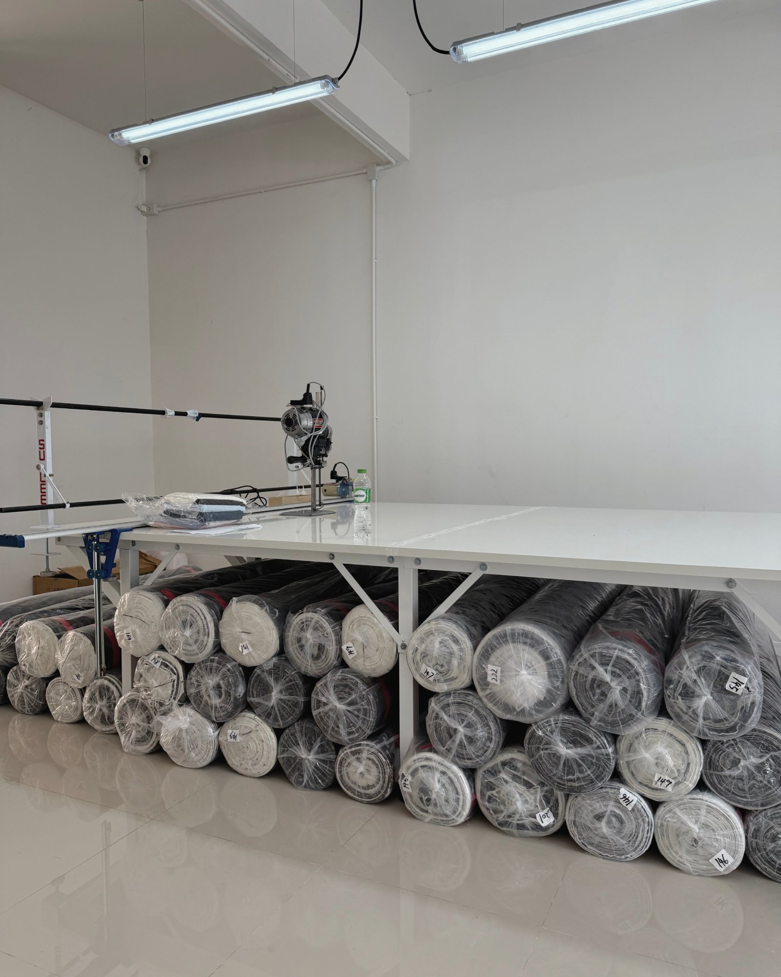 890 Factory cutting room — fabric rolls and cutting table